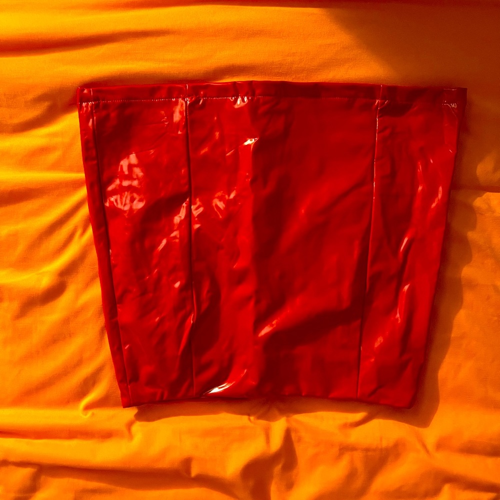 Upside down picture of small red pleather skirt